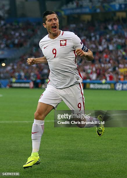 Robert Lewandowski of Poland celebrates scoring the opening goal during the UEFA Euro 2016 Quarter Final match between Poland and Portugal at Stade...