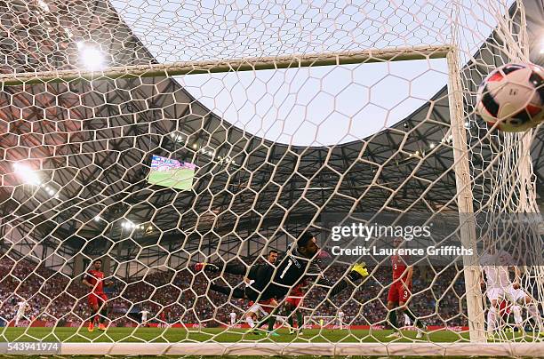 Rui Patricio of Portugal dives in vain as Robert Lewandowski of Poland scores the opening goal during the UEFA EURO 2016 quarter final match between...