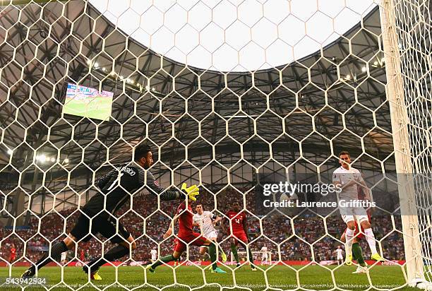 Robert Lewandowski of Poland scores the opening goal past Rui Patricio of Portugal during the UEFA EURO 2016 quarter final match between Poland and...