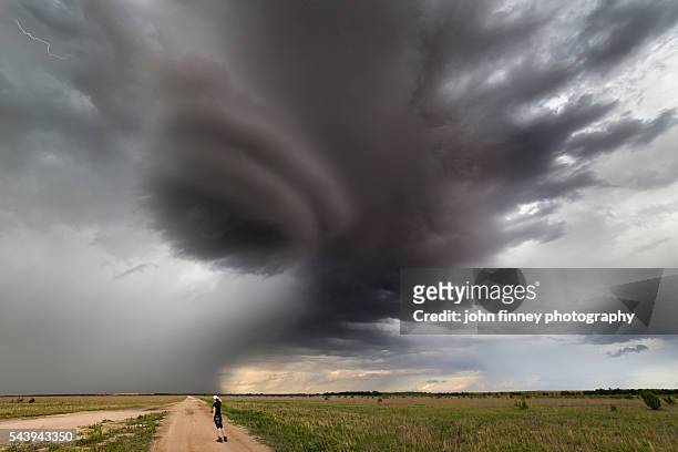 single female watching storm front sweeping across texas. unusual storm cloud. texas, usa - cyclone warning stock pictures, royalty-free photos & images