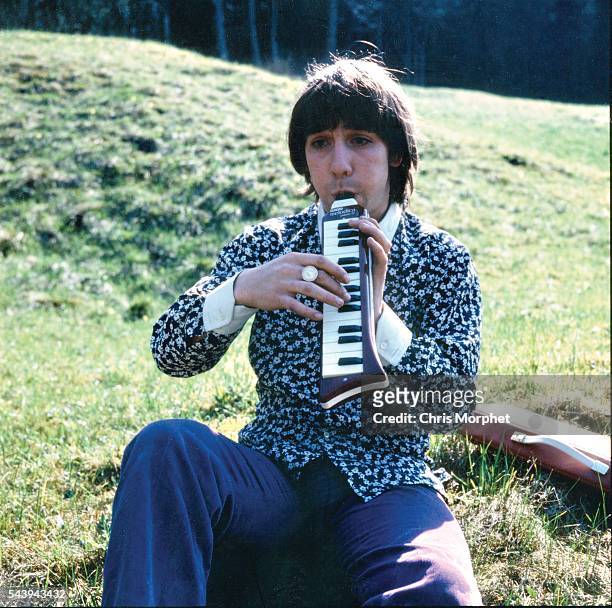 Portrait of The Who drummer Keith Moon, playing a melodica outdoors during the band's German tour, April 1967.
