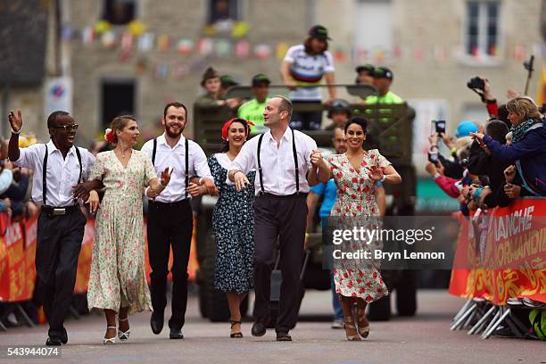 People dressed in period clothing join the Team Presentation parade ahead of the 2016 Tour de France at on June 30, 2016 in Sainte-Mere-Eglise,...