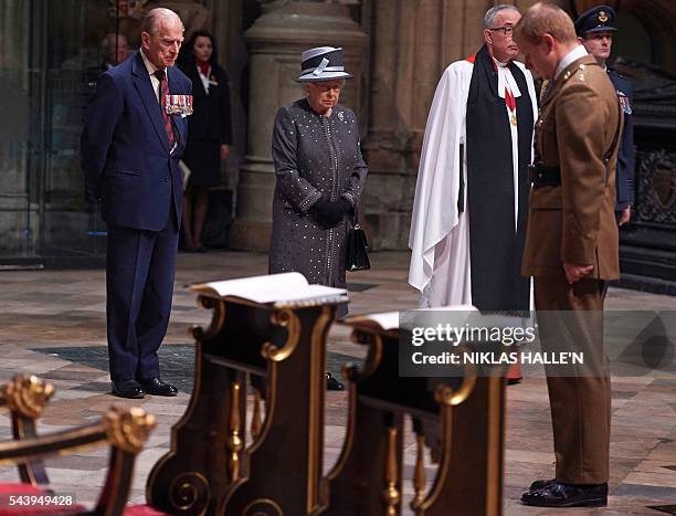 Britain's Queen Elizabeth II and Britain's Prince Philip, Duke of Edinburgh stand, after the bugler finishes playing at the end of a Service on the...