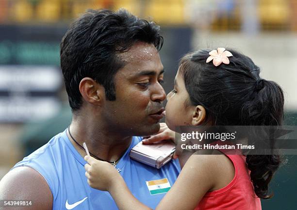 Indian Tennis player Leander Paes kissing his daughter after winning the match against Brazil's Marcelo Mello & Bruno Soares in doubles Davis Cup at...