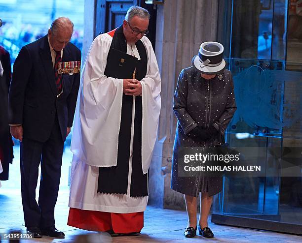The Dean of Westminster, Very Reverend Dr John Hall , Britain's Queen Elizabeth II and Britain's Prince Philip, Duke of Edinburgh bow, as they leave...