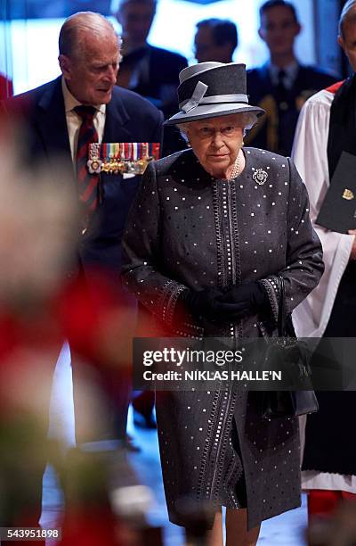 Britain's Queen Elizabeth II and Britain's Prince Philip, Duke of Edinburgh arrive to attend a Service on the Eve of the Centenary of the Battle of...