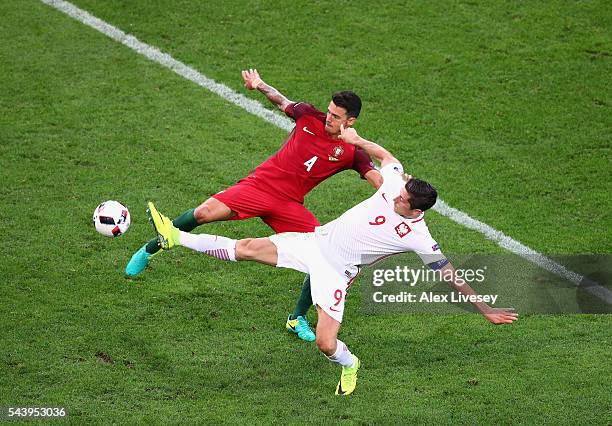 Robert Lewandowski of Poland and Jose Fonte of Portugal compete for the ball during the UEFA EURO 2016 quarter final match between Poland and...