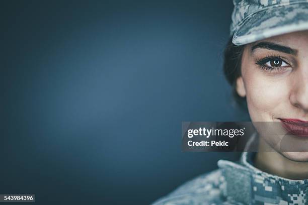 smiling female soldier - military uniform close up stock pictures, royalty-free photos & images