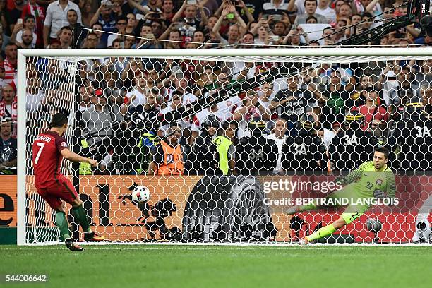 Portugal's forward Cristiano Ronaldo scores the first in a penalty shoot-out during the Euro 2016 quarter-final football match between Poland and...