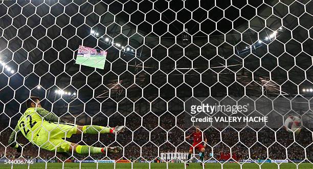 Portugal's forward Cristiano Ronaldo scores the first in a penalty shoot-out during the Euro 2016 quarter-final football match between Poland and...