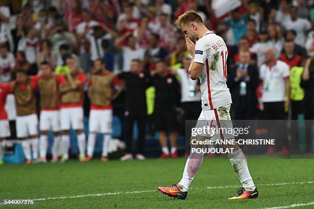 Poland's midfielder Jakub Blaszczykowski reacts after missing a shot in a penalty shoot-out during the Euro 2016 quarter-final football match between...