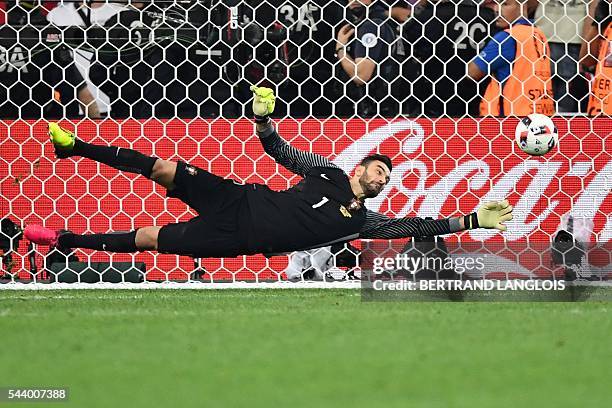 Portugal's goalkeeper Rui Patricio stops a shot in a penalty shoot-out during the Euro 2016 quarter-final football match between Poland and Portugal...