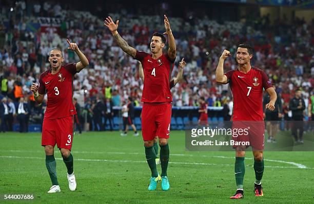 Pepe, Jose Fonte and Cristiano Ronaldo of Portugal celebrate their team's win after the UEFA EURO 2016 quarter final match between Poland and...
