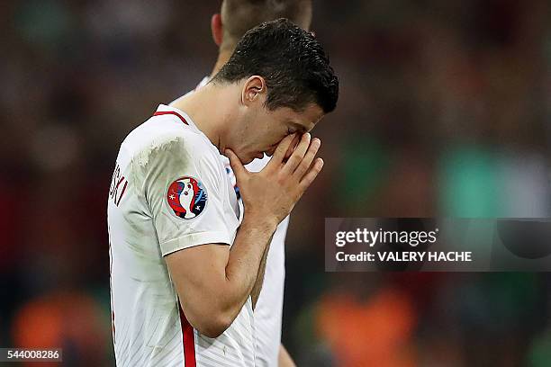 Poland's forward Robert Lewandowski reacts after the Euro 2016 quarter-final football match between Poland and Portugal at the Stade Velodrome in...