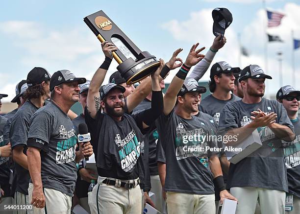 Head coach Gary Gilmore and player Anthony Marks of the Coastal Carolina Chanticleers celebrate with the team after defeating the Arizona Wildcats...