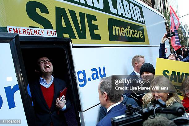 Federal Labor Senator Sam Dastyari laughs as Opposition Leader, Australian Labor Party Bill Shorten prepares to board the campaign bus following a...