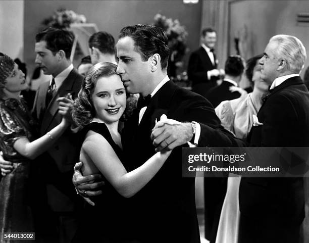 Actors Humphrey Bogart and Priscilla Lane pose for a publicity still for the Warner Bros film 'Men Are Such Fools' in 1938 in Los Angeles, California.