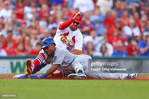 Jarrod Dyson of the Kansas City Royals is caught stealing third base by Greg Garcia of the St. Louis Cardinals in the second inning at Busch Stadium...