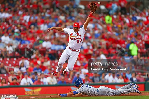 Whit Merrifield of the Kansas City Royals steals third base against Jhonny Peralta of the St. Louis Cardinals in the first inning at Busch Stadium on...