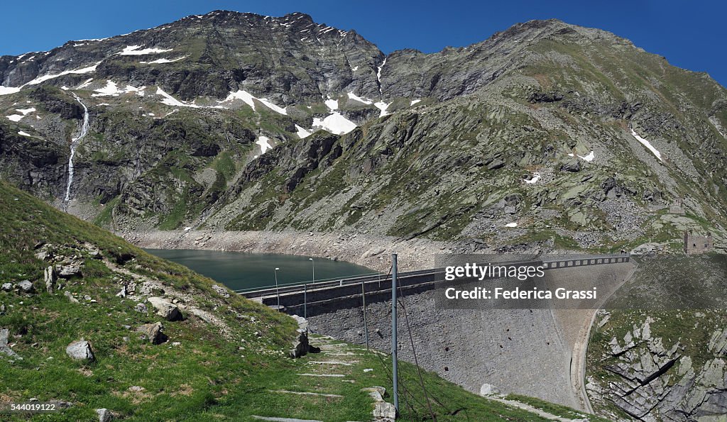 Panorama View Of The Cingino Dam With Climbing Wild Ibex Goats High Res panorama-view-of-the-cingino-dam-with-climbing-wild-ibex-goats-high-res