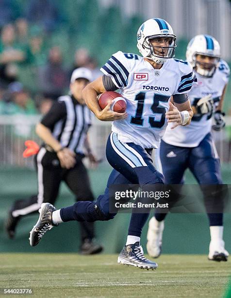 Ricky Ray of the Toronto Argonauts scrambles with the ball in first half action during the game between the Toronto Argonauts and Saskatchewan...