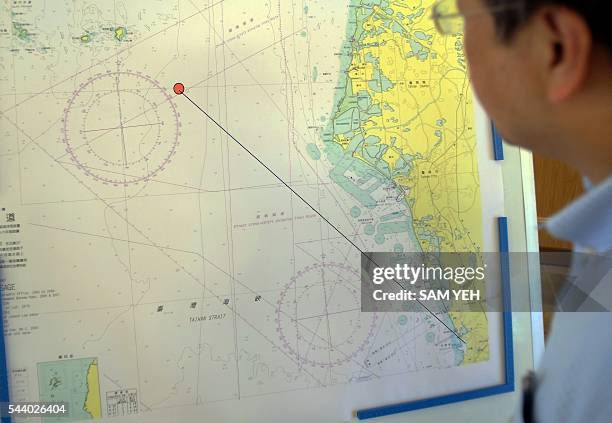 Journalist looks at a map showing the misfired missile route during a press conference in Taipei on July 1, 2016. Taiwan's military authorities said...