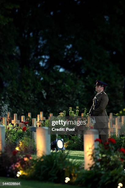 Soldier stands amongst the war graves during a military-led vigil to commemorate the 100th anniversary of the beginning of the Battle of the Somme at...