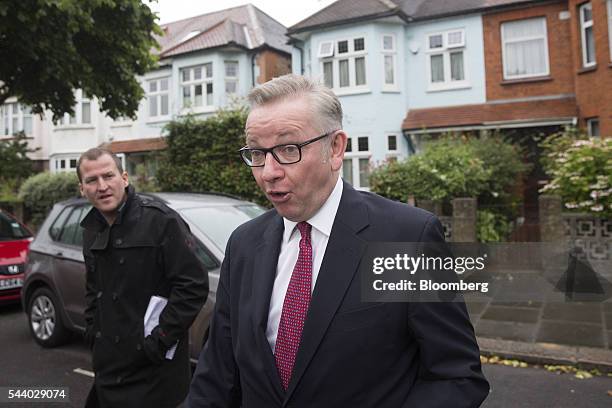 Michael Gove, U.K. Justice secretary, right, looks on as he leaves his home in London, U.K., on Friday, July 1, 2016. Hours after his announcement,...