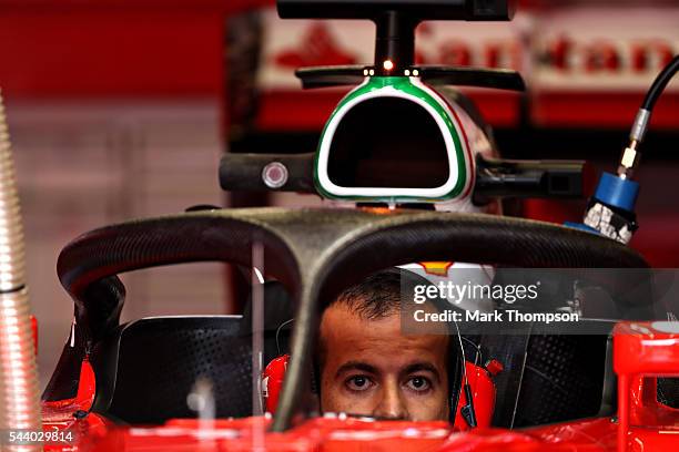 Ferrari mechanic works on the car fitted with the halo in the garage before practice for the Formula One Grand Prix of Austria at Red Bull Ring on...