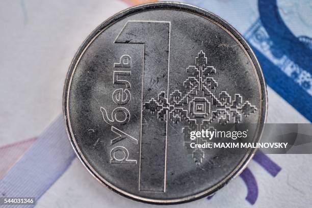 New Belarus ruble coin is pictured in Minsk on July 1, 2016. - Belarus is slashing four zeros from banknotes, the central bank said on June 30, in a...
