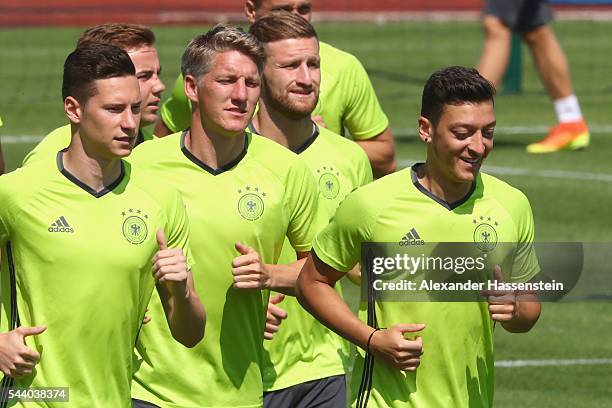 Julian Draxler, Mario Goetze, Bastian Schweinsteiger, Shkodran Mustafi and Mesut Oezil of Germany runs during a Germany training session ahead of...