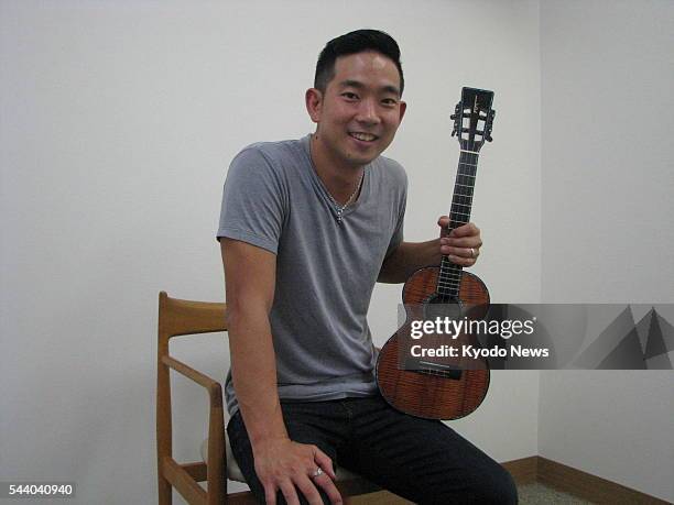 Jake Shimabukuro poses with his ukulele before a live performance in Tokyo on June 25, 2016. Born and raised in Hawaii, Shimabukuro is a...