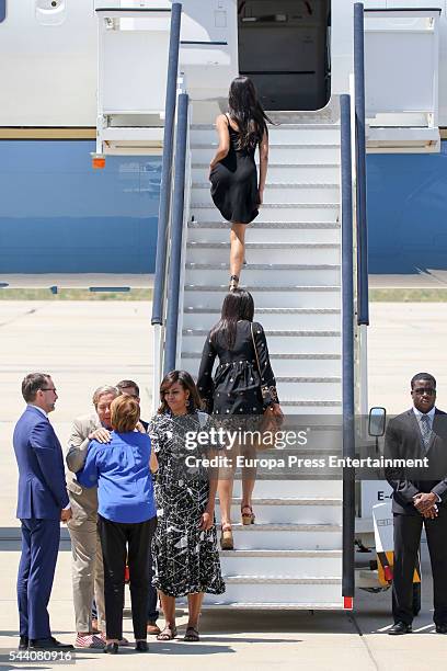 First Lady Michelle Obama , her daughters Malia Obama and Sasha Obama and her mother Marian Robinson board an official plane prior to her departure...