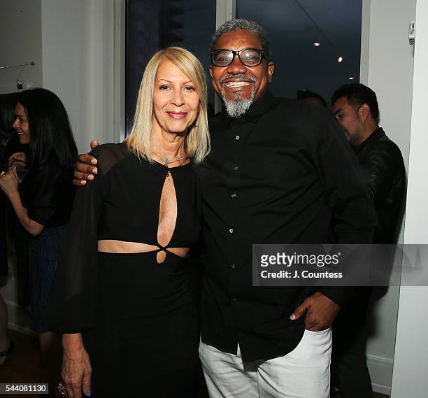 Rona Siegel and photographer Marc Baptiste pose for a photo at the "Other Color" By Marc Baptiste Opening at the apART Private Gallery on June 30,...