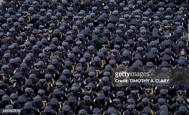Graduating officers with the New York Police Department 2016 graduation class attend a ceremony at Madison Square Garden July 2016. / AFP PHOTO /...