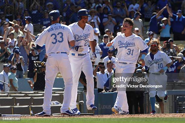 Scott Van Slyke of the Los Angeles Dodgers crosses home plate for the game-winning run in the ninth inning against the Milwaukee Brewers as Will...