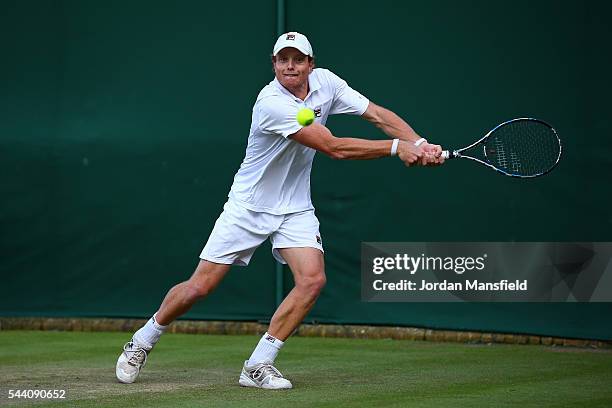 Matthew Barton of Australia plays a backhand during the Men's Singles second round match against John Isner of The United States on day five of the...