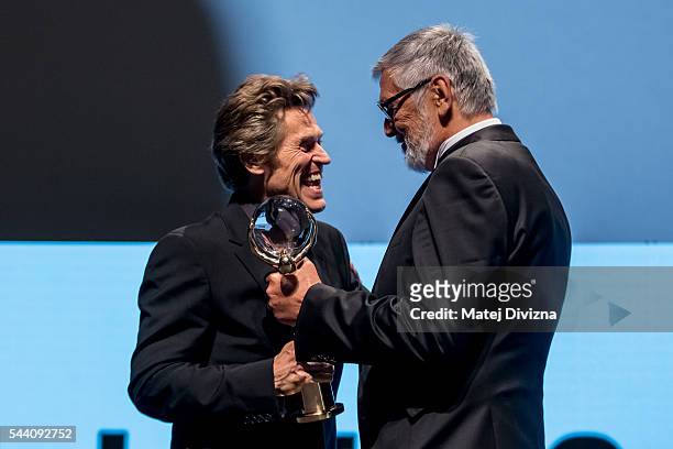 Actor Willem Dafoe receives the Crystal Globe Award for Outstanding Artistic Contribution to World Cinema from President of Karlovy Vary...