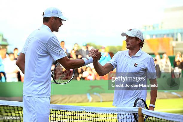 John Isner of The United States shakes hands with Matthew Barton of Australia in the Men's Singles second round match on day five of the Wimbledon...