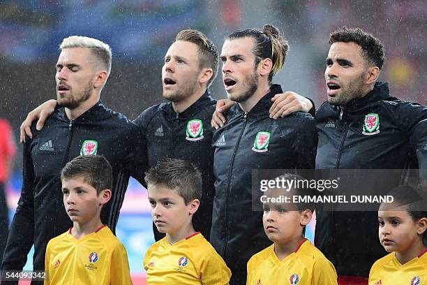 Wales' midfielder Aaron Ramsey, Wales' defender Chris Gunter, Wales' forward Gareth Bale and Wales' forward Hal Robson-Kanu sing the national anthem...