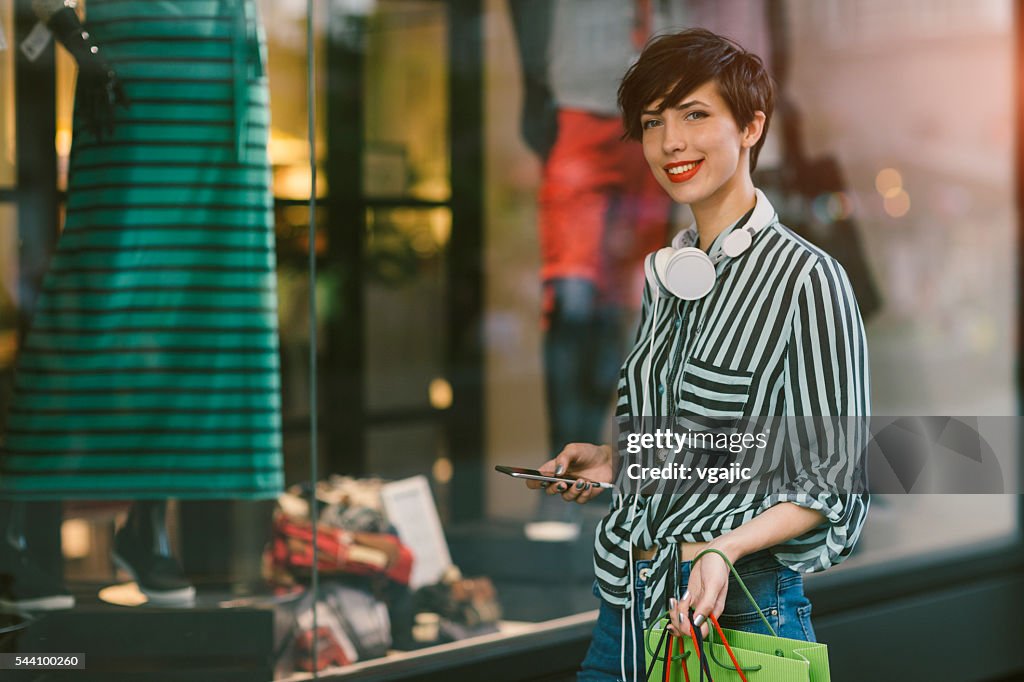 Young Woman Using Smart Phone In The City
