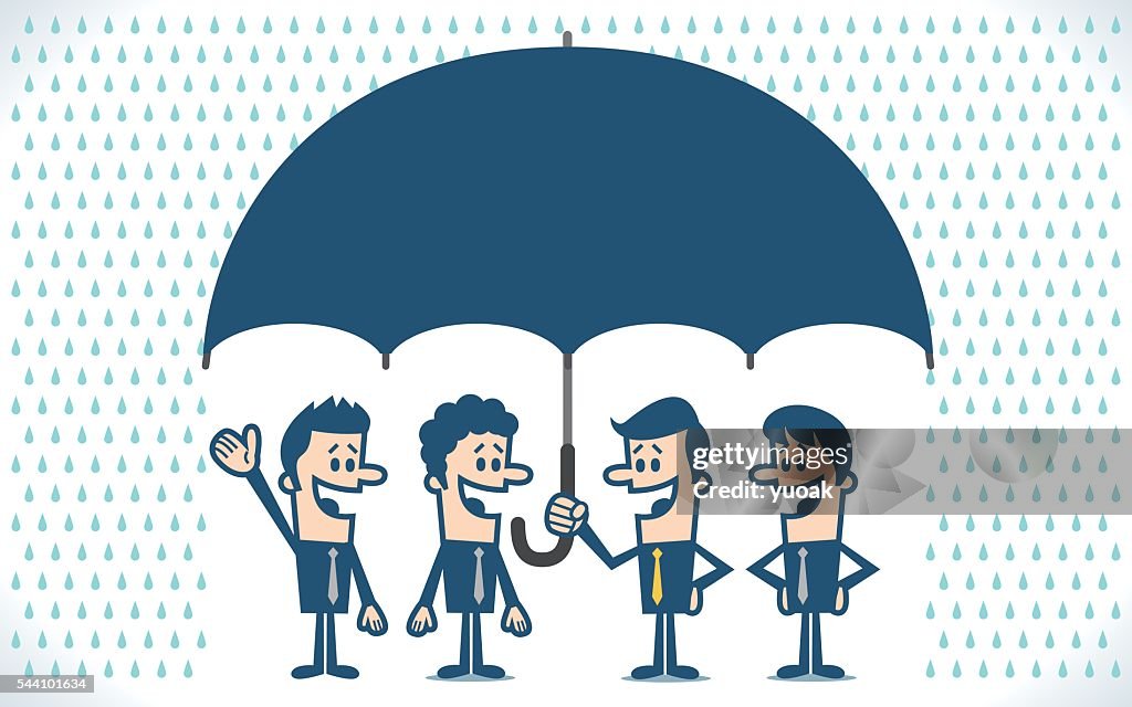 Businessman protecting businessmen with his umbrella