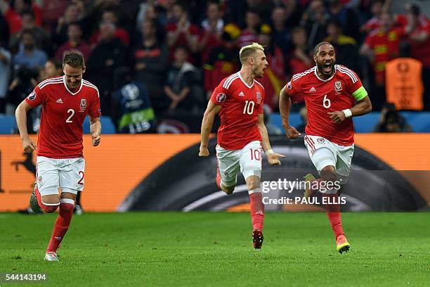 Wales' defender Ashley Williams celebrates after scoring a goal with team mates Wales' defender Chris Gunter and Wales' midfielder Aaron Ramsey...