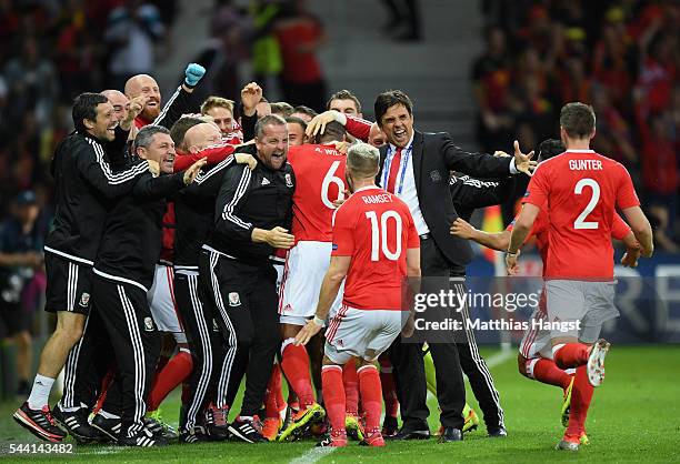 Chris Coleman manager of Wales congratulates Ashley Williams and players after his team's first goal during the UEFA EURO 2016 quarter final match...