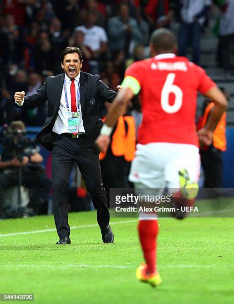 Chris Coleman manager of Wales congratulates Ashley Williams after scoring their first goal during the UEFA EURO 2016 quarter final match between...