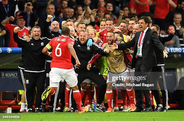 Chris Coleman manager of Wales celebrates Ashley Williams of after scoring his team's first goal during the UEFA EURO 2016 quarter final match...