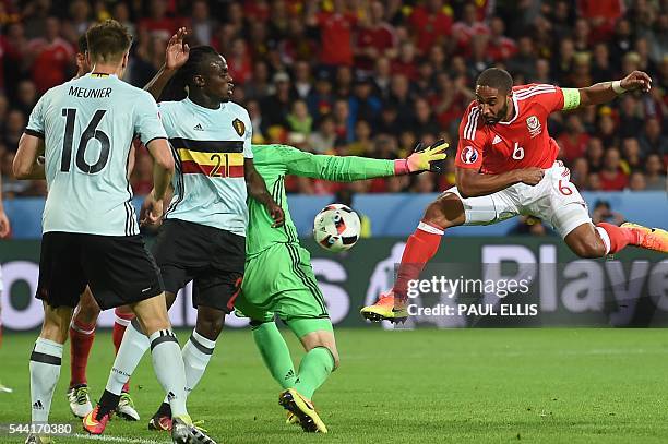 Wales' defender Ashley Williams vies for the ball with Belgium's players during the Euro 2016 quarter-final football match between Wales and Belgium...