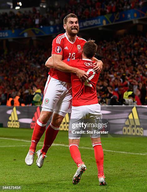 Sam Vokes of Wales celebrates scoring his team's third goal with his team mates Chris Gunter during the UEFA EURO 2016 quarter final match between...