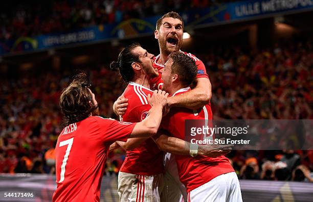 Sam Vokes of Wales celebrates scoring his team's third goal with his team mates during the UEFA EURO 2016 quarter final match between Wales and...