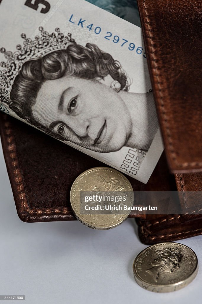 Wallet with a 5 Pounds banknote and a 1 Pounds coin.